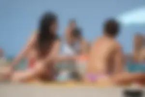 2 topless girls at the beach in thongs