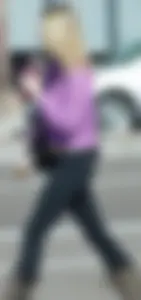 Beautiful skinny blonde in tight leggings and purple crop top showing sexy stomach