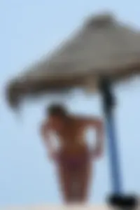 Hot beach girl undressing and going topless