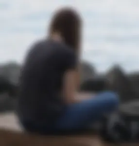 Cute brunette in jeans by the water