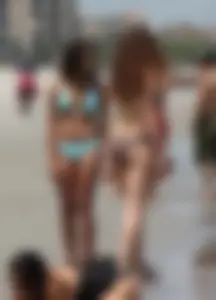 Brunette and redhead on the beach in bikinis looking sexy