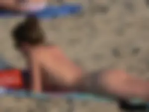 Sexy babe with a nice body topless and in a thong on the beach