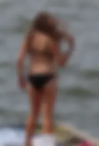 Thick babe with big boobs in a black bikini