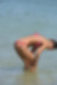 Sexy beach babe in pink bikini makes it a string bikini