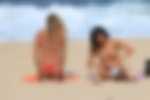 Sexy girls topless on a nude beach showing their nice tits