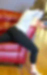 Sexy girl sitting in sexy position on a couch in leggings