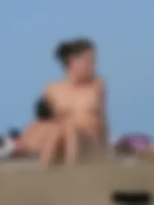 Sexy babe with a nice body topless and in a thong on the beach