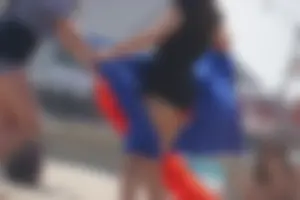 A group of teens in bikinis on the beach