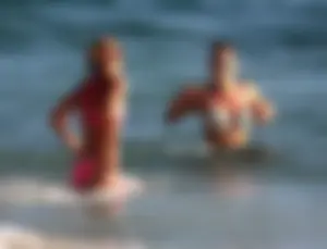 Sexy beach girl in bikini with her other sexy friend