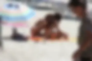 Topless milf and her topless daughter on the beach