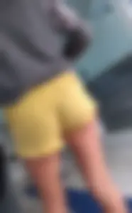 Skinny ass eating her yellow shorts