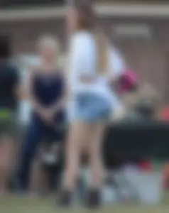Hippie type dressed girl in denim shorts with a nice ass