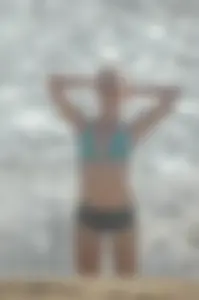 Blonde lady on the beach in bikini top and spandex shorts with a nice gap