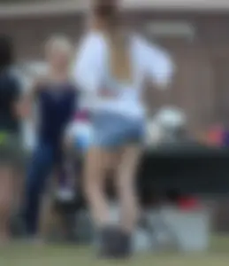 Hippie type dressed girl in denim shorts with a nice ass