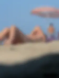 Sexy babe with a nice body topless and in a thong on the beach
