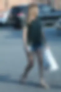Cutie walking in the parking lot in jean shorts