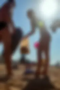 Sexy blonde milf on the beach in blue thong bikini and showing nice camel toe