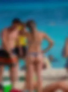 A few sexy girls with great asses in thong bikinis at the beach
