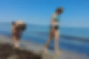 2 sexy friends in bikinis walking on the beach