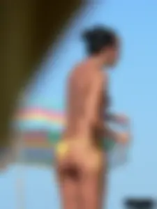 Bunch of sexy babes on the beach topless and in thong bikinis