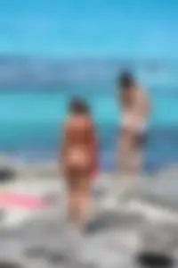 Older lady on a nude beach showing her body
