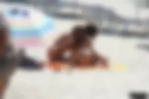 Topless milf and her topless daughter on the beach