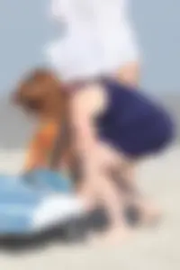 Pale redhead girl with thick booty and flat chest on the beach in her bikini
