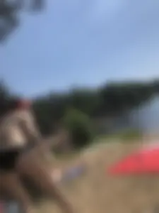 Skinny Girl in Swimsuit Lying on the Lake Beacg Topless and Bending Over