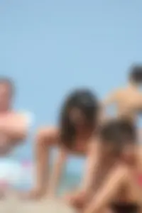 2 topless girls at the beach in thongs