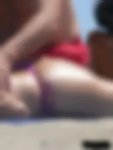 Purple thong topless lady on the beach gets oiled up by her husband