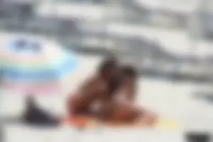 Topless milf and her topless daughter on the beach