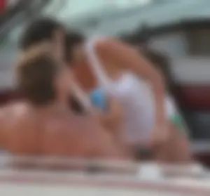 Bikini babe on a boat with a wet see through white shirt showing her tits