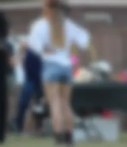 Hippie type dressed girl in denim shorts with a nice ass