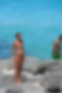 Older lady on a nude beach showing her body
