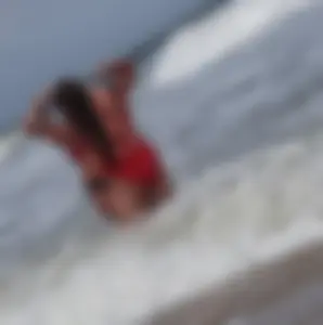 Fat chick on the beach in a red swimsuit