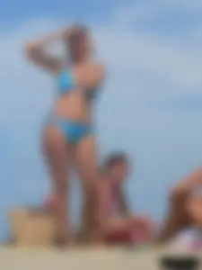 Sexy lady on the beach in a blue thong bikini