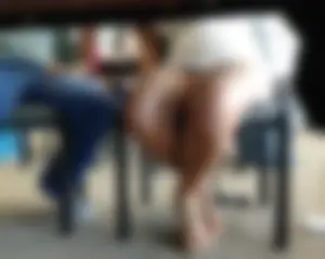 Sexy brunette upskirted showing her blue panties under the table