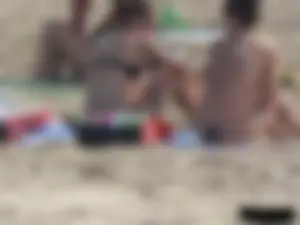 Sexy babe with a nice body topless and in a thong on the beach