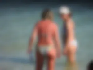 Blonde milf on the beach in her bikini