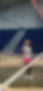 Bunch of cute college girls in bright pink shorts playing volleyball