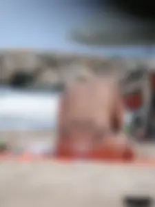 Tattooed blonde with big tits topless and in thong