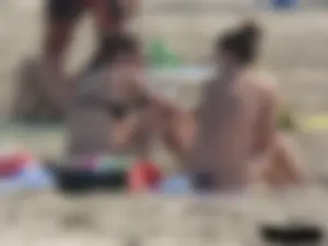 Sexy babe with a nice body topless and in a thong on the beach