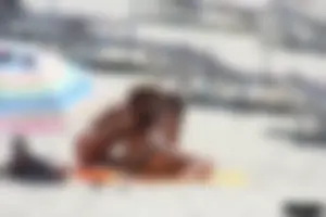 Topless milf and her topless daughter on the beach