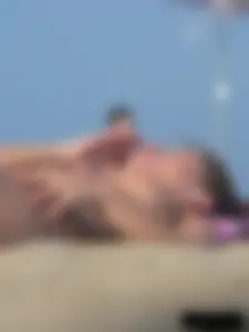 Sexy babe with a nice body topless and in a thong on the beach