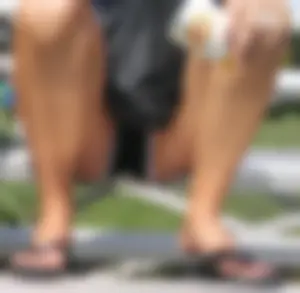 Girl in Shorts And Slippers Sitting With Spread Legs at a Street Sporting Ground Creepshot - Her Crotch Clearly Visible