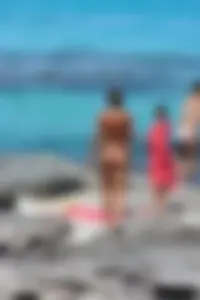 Older lady on a nude beach showing her body
