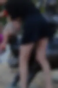 Skinny young milf wearing a skirt and sandals with heels bend over on the street, amazing hot legs