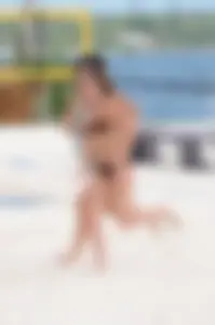 Two sexy girls playing tennis in bikinis