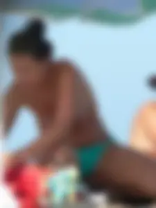 Bunch of sexy babes on the beach topless and in thong bikinis