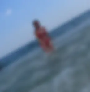 Sexy girl at the beach in a red thong bikini with nice tits and ass